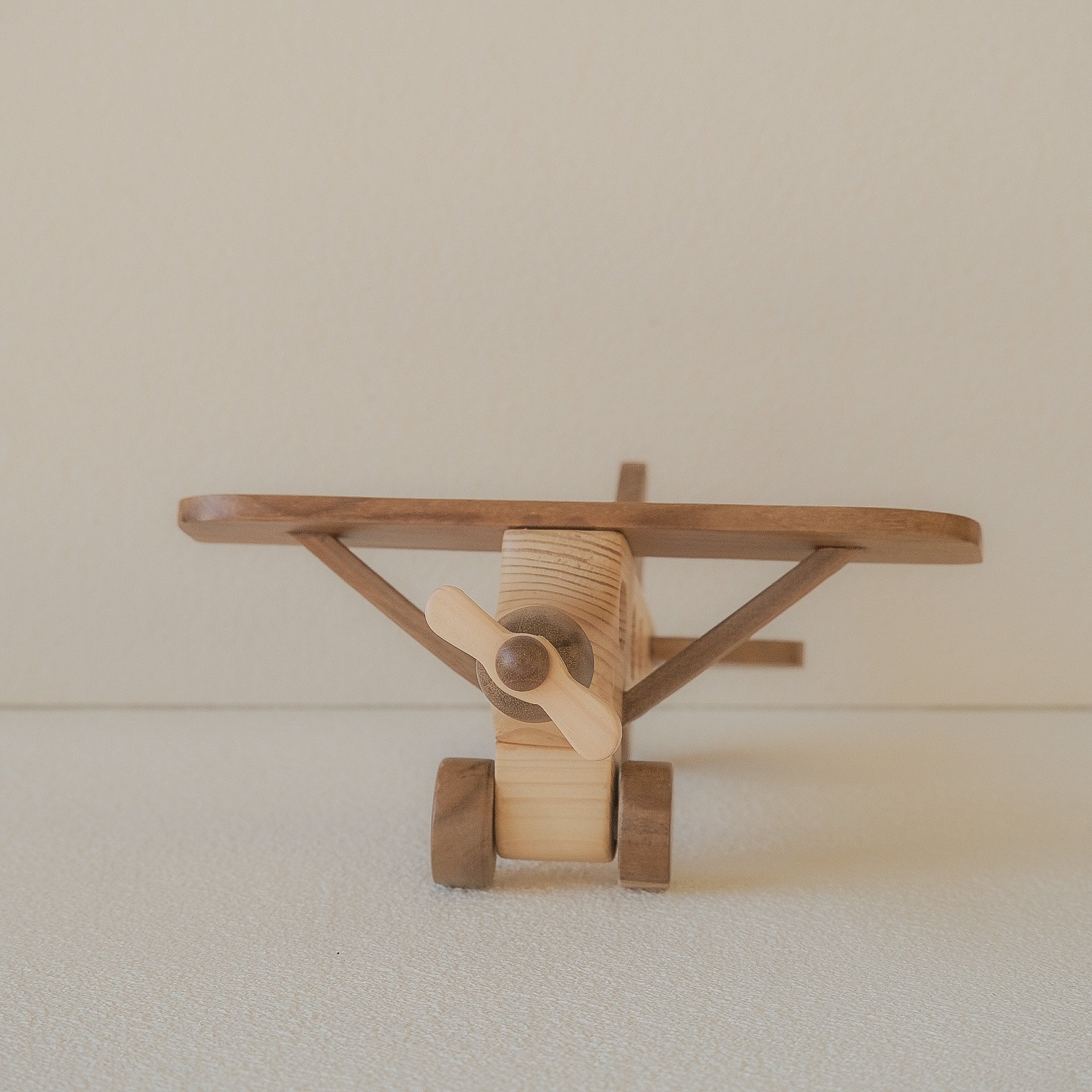 Wooden toy airplane on a plain background