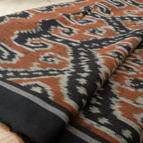 Amber Dusk Handloom Blanket – A fully handwoven cotton throw in rich amber and black hues, crafted using traditional handloom techniques.