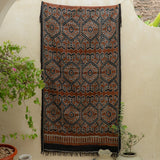 Amber Dusk Handloom Blanket – A fully handwoven cotton throw in rich amber and black hues, crafted using traditional handloom techniques.
