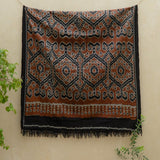 Amber Dusk Handloom Blanket – A fully handwoven cotton throw in rich amber and black hues, crafted using traditional handloom techniques.