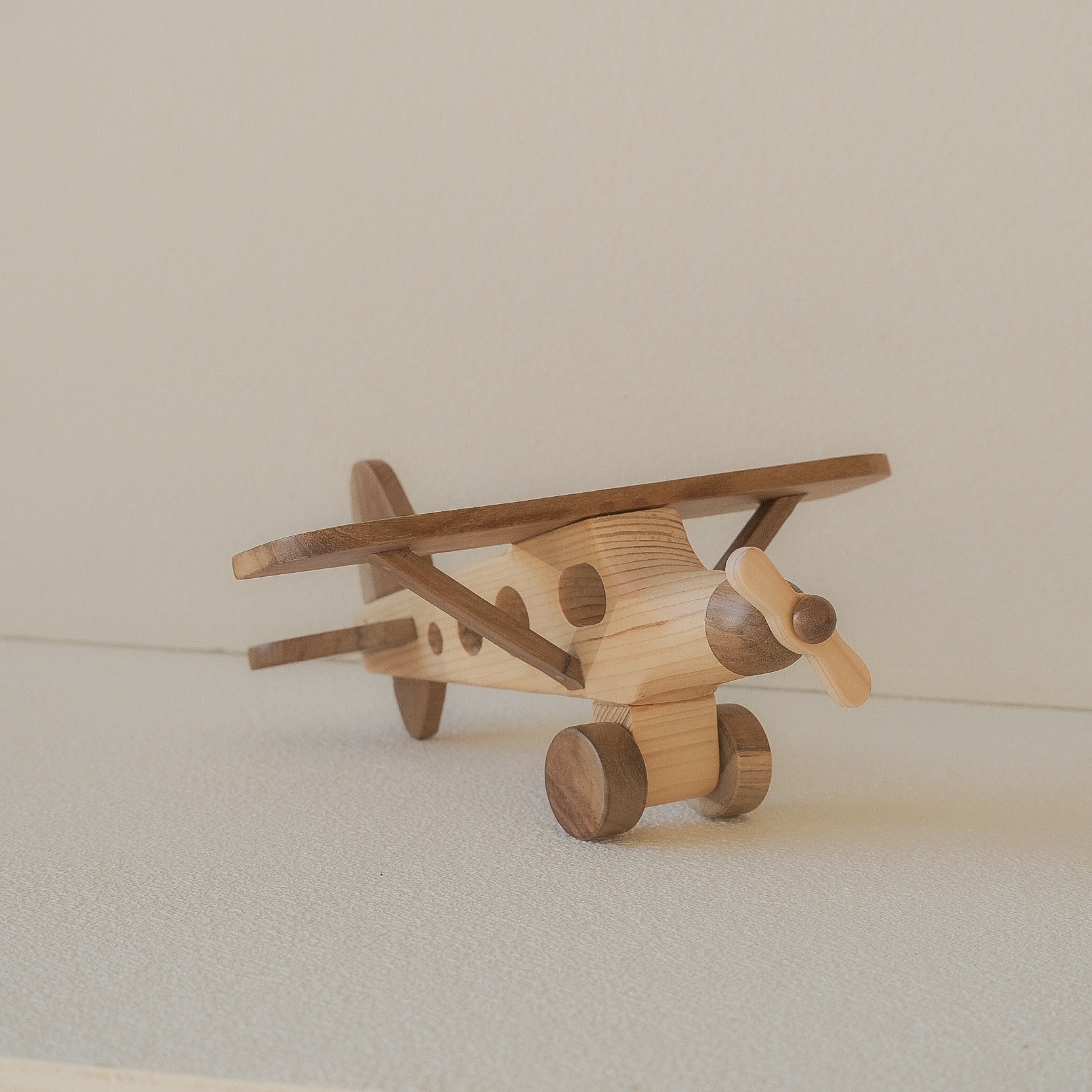 Wooden toy airplane on a light background