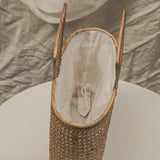 Woven basket with a white interior on a neutral background