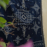 Indigo Eclipse Handloom Blanket, handwoven from 100% natural cotton with intricate patterns in deep indigo hues, crafted using traditional techniques.