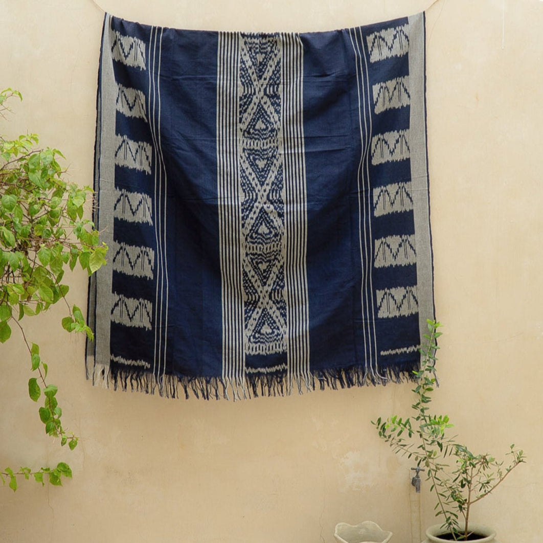 Indigo Horizon Handloom Blanket – A fully handwoven cotton throw with intricate patterns, crafted using traditional handloom techniques.
