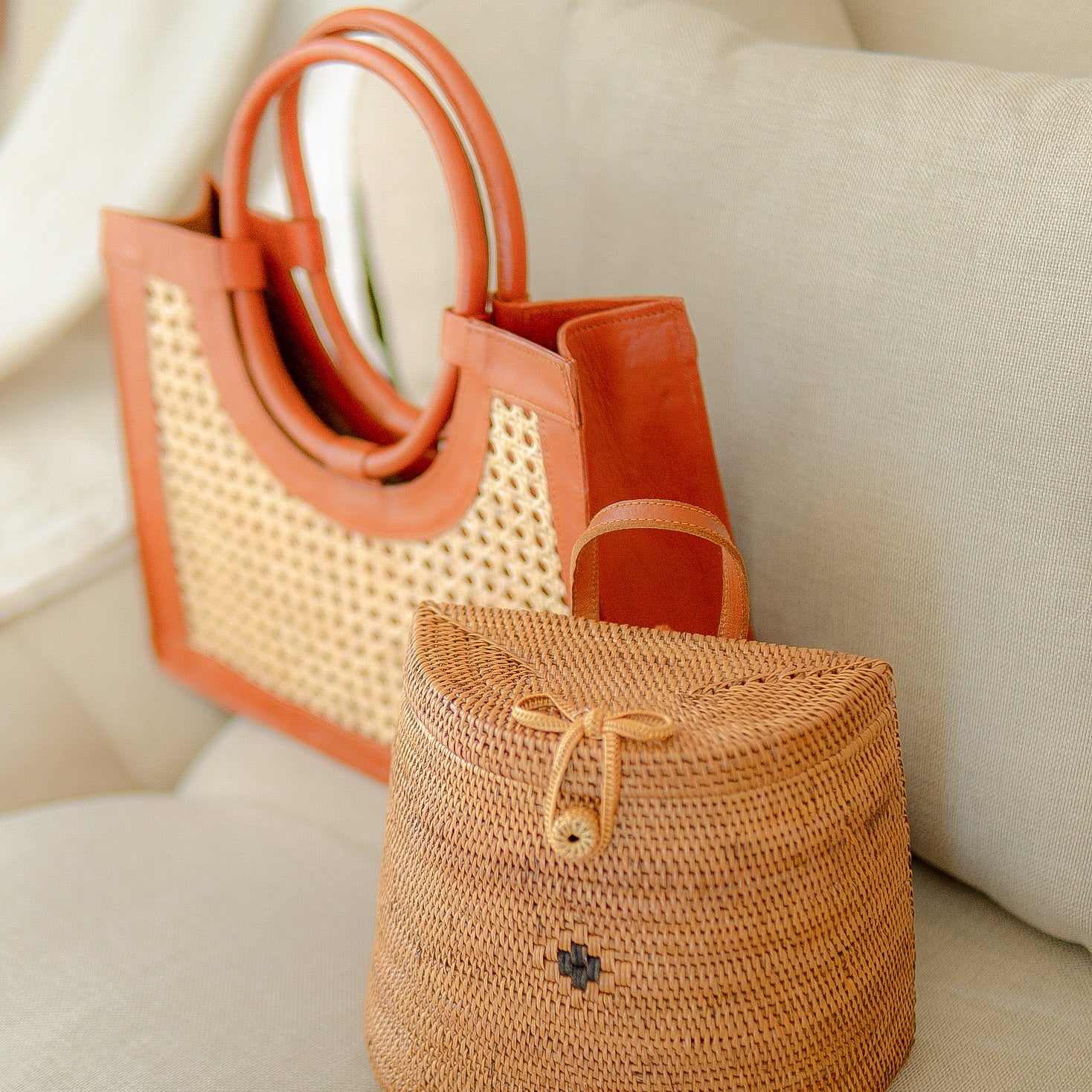 Woven handbag with leather accents on a light-colored surface