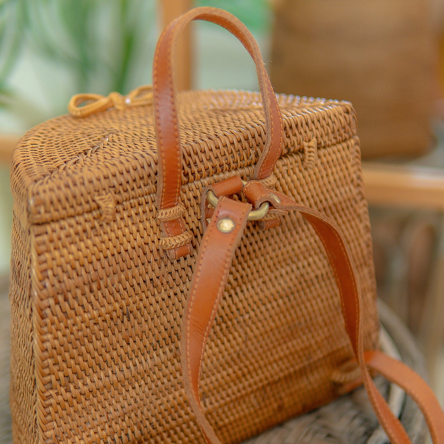 Pipa woven handbag with leather straps on a blurred natural background