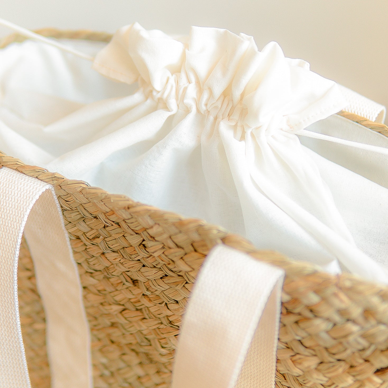 White fabric draped over a woven basket on a light background