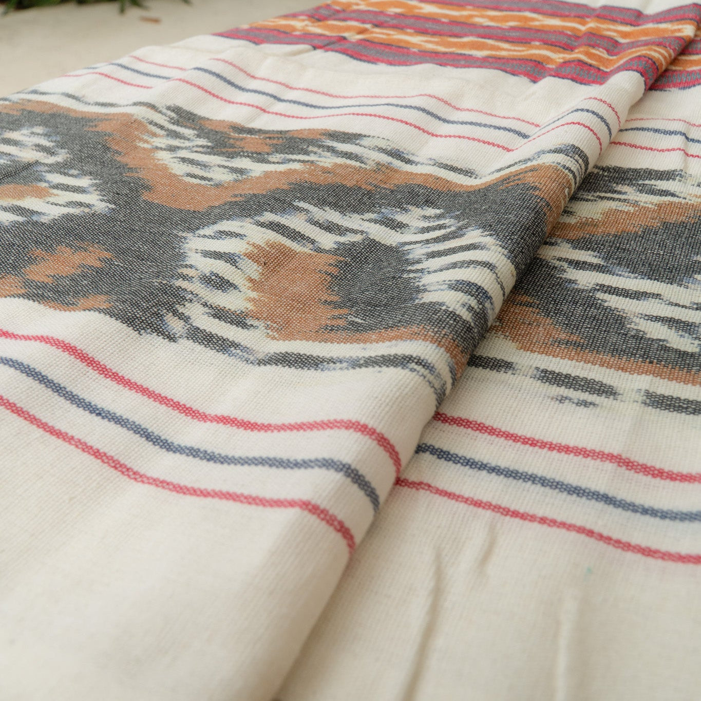 Sierra Handloom Blanket featuring a geometric pattern in earthy tones, crafted using traditional handloom techniques.