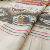 Sierra Handloom Blanket featuring a geometric pattern in earthy tones, crafted using traditional handloom techniques.