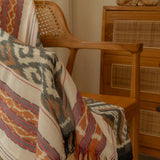 Sierra Handloom Blanket featuring a geometric pattern in earthy tones, crafted using traditional handloom techniques.