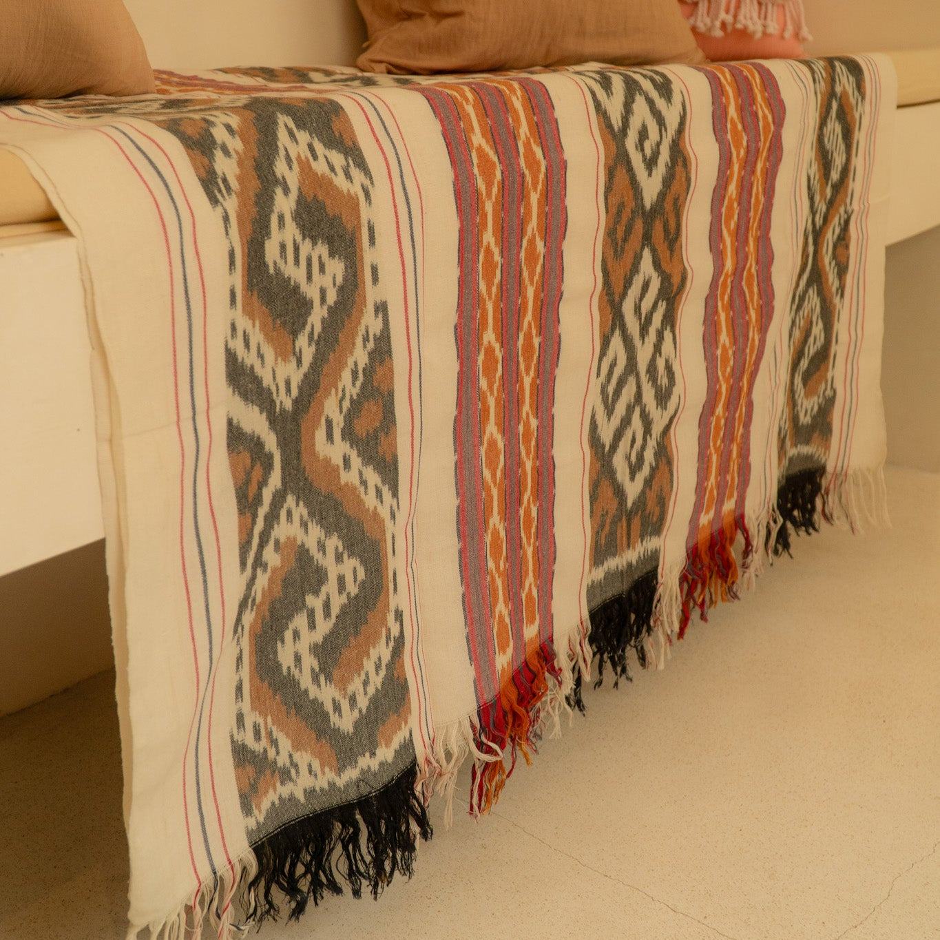 Sierra Handloom Blanket featuring a geometric pattern in earthy tones, crafted using traditional handloom techniques.