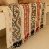 Sierra Handloom Blanket featuring a geometric pattern in earthy tones, crafted using traditional handloom techniques.