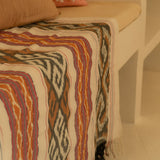Sierra Handloom Blanket featuring a geometric pattern in earthy tones, crafted using traditional handloom techniques.
