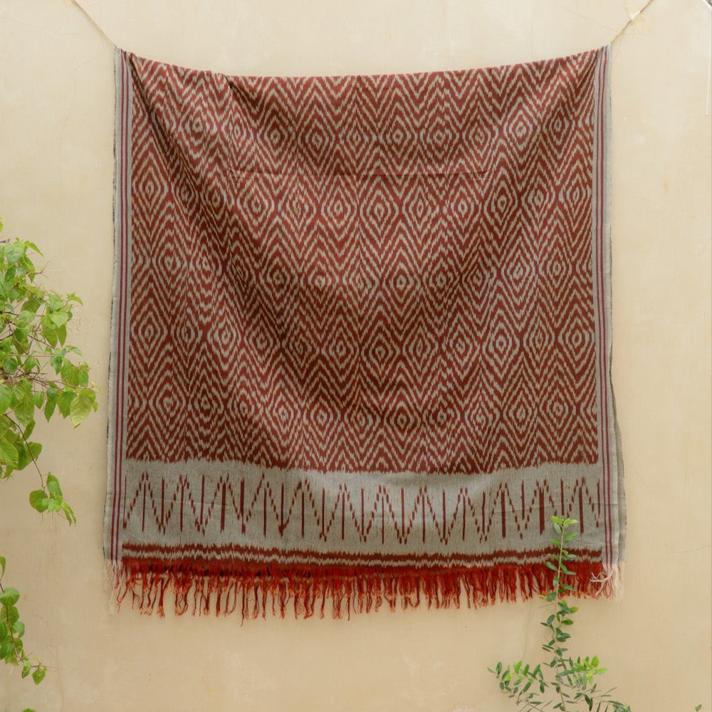 Terracotta Dawn Handloom Blanket – A fully handwoven cotton throw with intricate terracotta and ivory patterns, crafted using traditional artisan techniques.