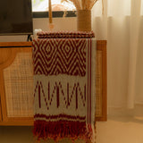 Terracotta Dawn Handloom Blanket – A fully handwoven cotton throw with intricate terracotta and ivory patterns, crafted using traditional artisan techniques.