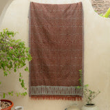 Terracotta Dawn Handloom Blanket – A fully handwoven cotton throw with intricate terracotta and ivory patterns, crafted using traditional artisan techniques.