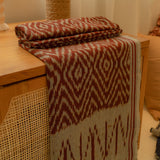 Terracotta Dawn Handloom Blanket – A fully handwoven cotton throw with intricate terracotta and ivory patterns, crafted using traditional artisan techniques.