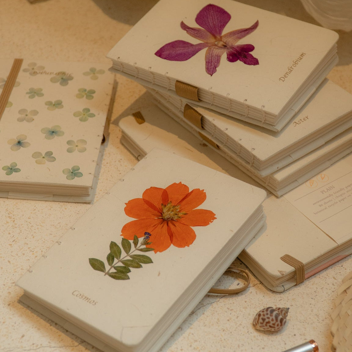 Bespoke hand-stitched A5 and A6 recycled paper journals with minimalist natural covers