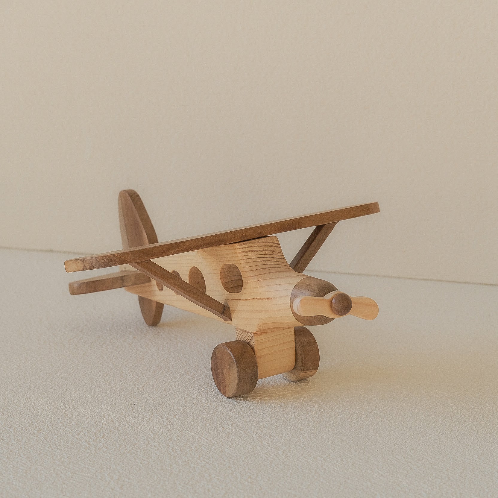 Wooden airplane toy on a light background