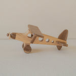 Wooden airplane toy on a plain background