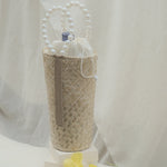 wine carrier bag made from natural pandan leaves in beige background