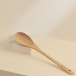 Wooden spatula on a beige background