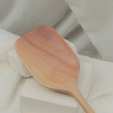 Wooden spatula on a white fabric background