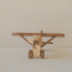 Wooden toy airplane on a plain background