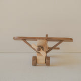Wooden toy airplane on a plain background