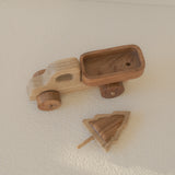Wooden toy car and truck on a beige surface
