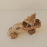 Wooden toy car with a driver figure on a beige surface