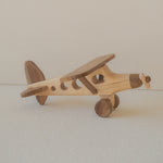 Wooden toy airplane on a plain background