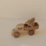 Wooden toy truck with an open bed on a beige surface