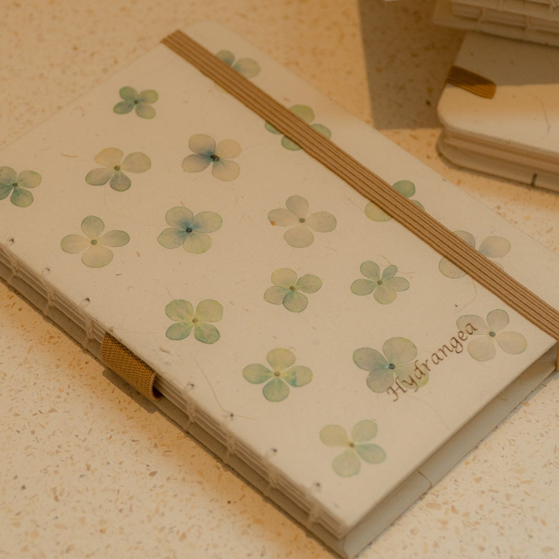 Notebook with floral design on a textured surface