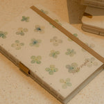 Notebook with floral design on a textured surface