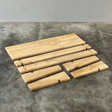 Wooden slats on a textured gray surface