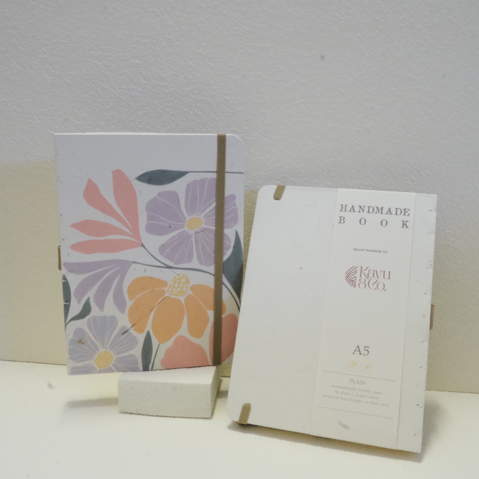 Sustainable hand-stitched notebook with vibrant floral market-inspired cover, made from upcycled newspapers, banana trunks, and dried leaves. Perfect for journaling and planning.