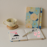 Hanami Morning Set – handmade journaling gift set with indigo blue floral journal, flower mug, natural wooden coaster, and pen for self-care and mindfulness