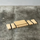 Wooden blocks stacked on a textured gray surface