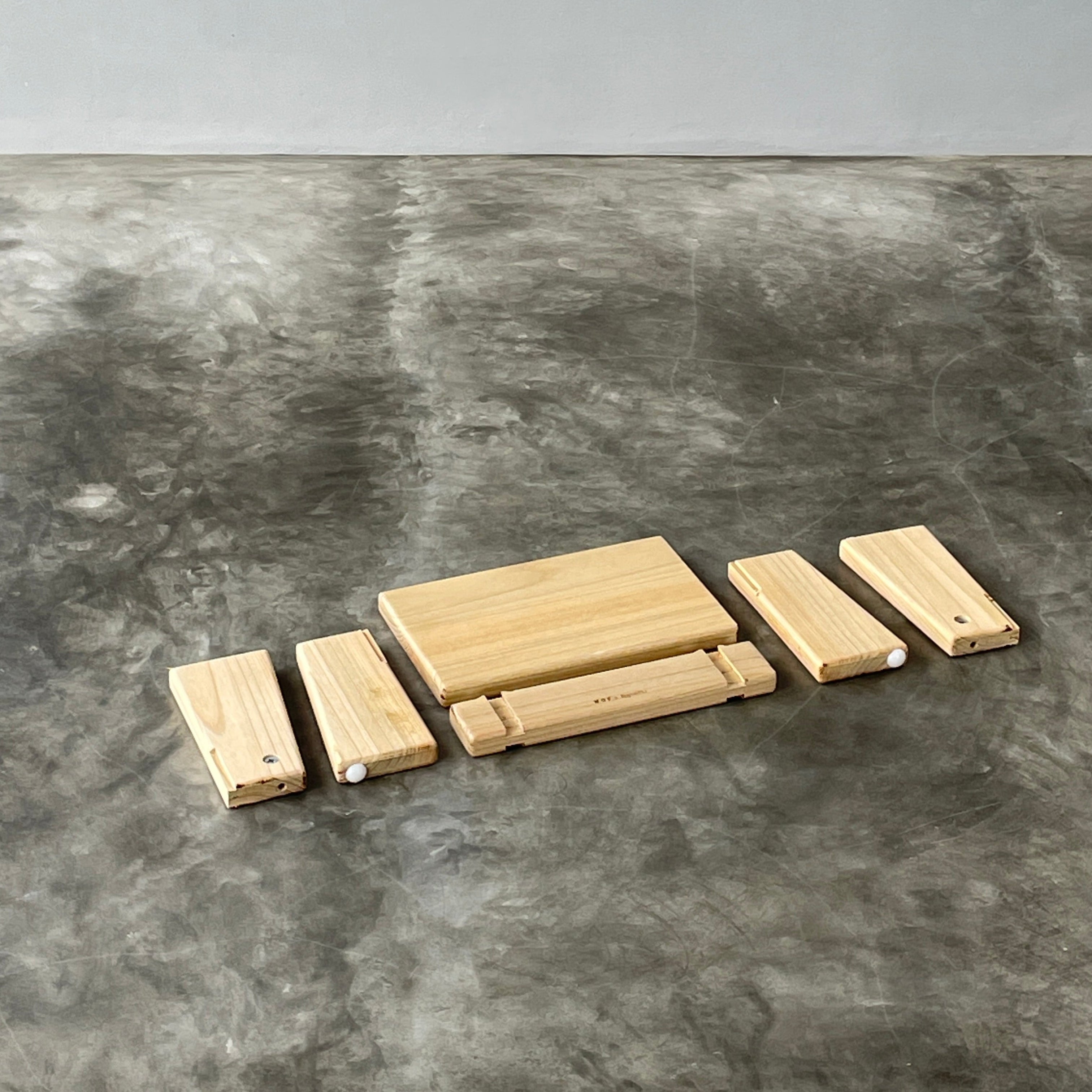 Wooden blocks stacked on a textured gray surface