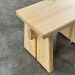 Wooden step stool on a gray concrete floor