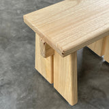 Wooden step stool on a gray concrete floor