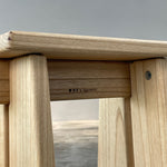 Wooden product with a brand logo on a gray background