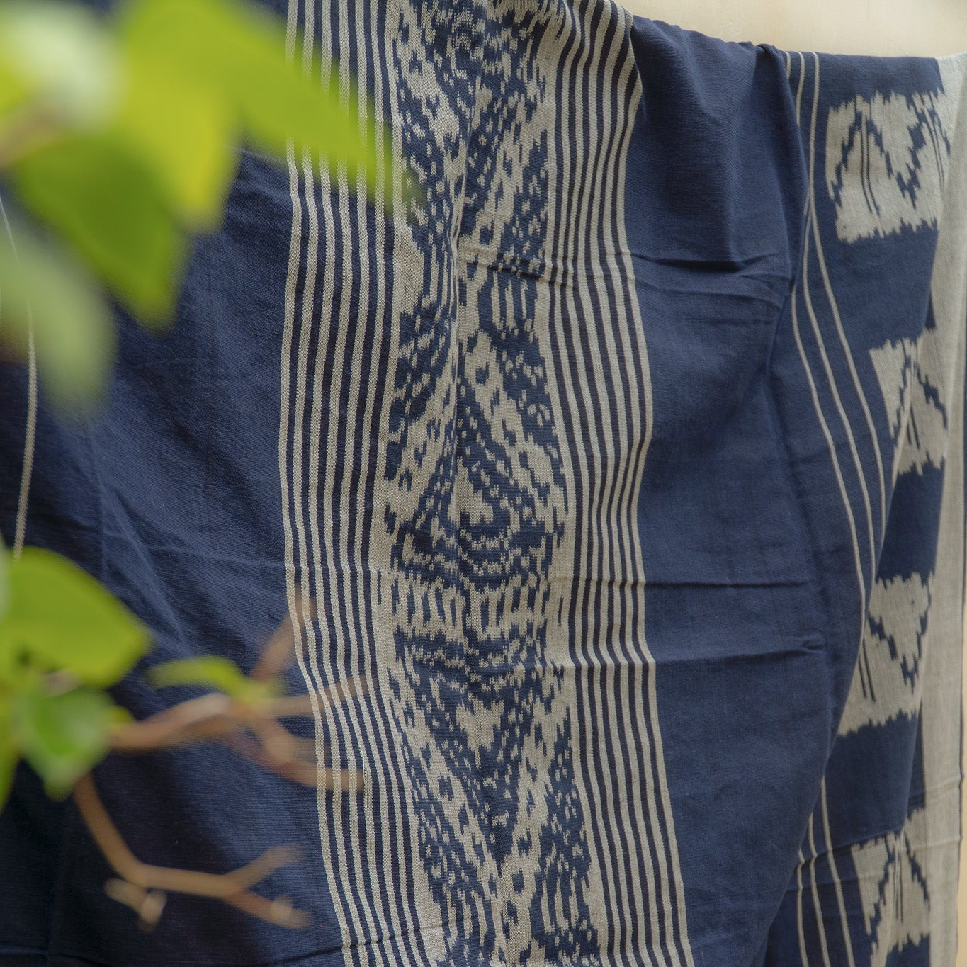 Indigo Horizon Handloom Blanket – A fully handwoven cotton throw with intricate patterns, crafted using traditional handloom techniques.