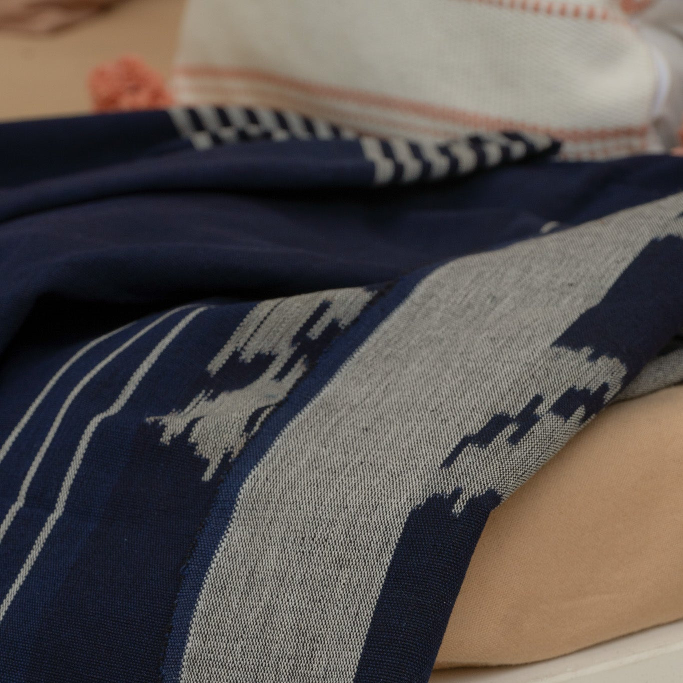 Indigo Horizon Handloom Blanket – A fully handwoven cotton throw with intricate patterns, crafted using traditional handloom techniques.