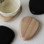 Set of 4 handcrafted Nami Wooden Pebble Coasters – available in Natural and Black Noir finish, wide smooth curved surface, eco-conscious Japandi style