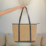 Sol tote bag with black straps held by a person against a neutral background