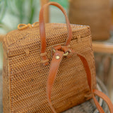 Pipa woven handbag with leather straps on a blurred natural background