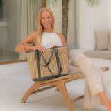 Woman holding a woven bag in a casual setting
