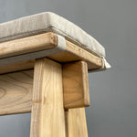Close-up of a wooden chair with a gray background